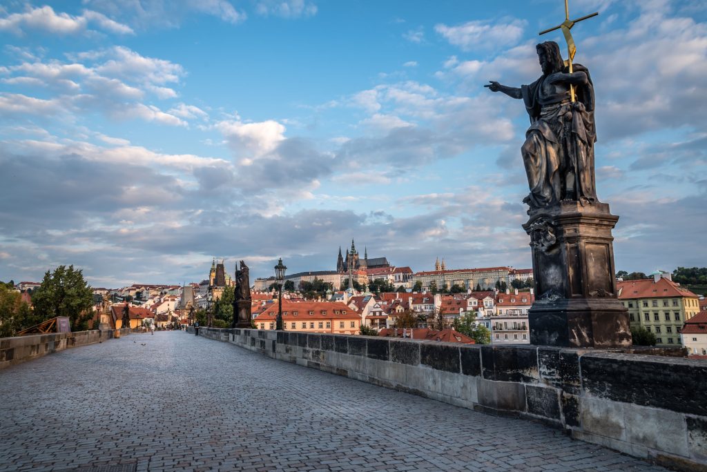 Charles Bridge in Prague against sky at sunrise.